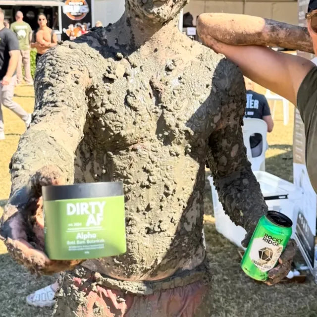 True grit — covered head to toe in mud, Alpha tub in hand